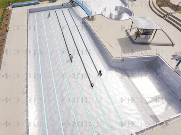 High-angle shot of an empty swimming pool under construction with metal walls, renewal of the swimming lines, Calw Stammheim outdoor pool, Calw, Black Forest, Germany