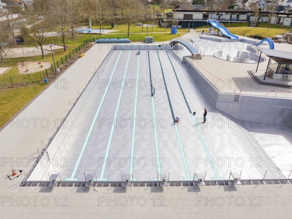 High-angle view of a swimming pool under construction with workers and trees, renewal of the swimming lines, Calw Stammheim outdoor pool, Calw, Black Forest, Germany