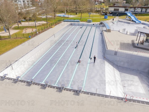 Swimming pool with workers and green surroundings in the distance, renewal of the swimming lines, outdoor swimming pool Calw Stammheim, Calw, Black Forest, Germany