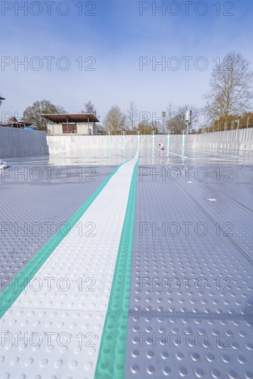 View along an empty swimming pool with striking stripes in the sun, renewal of the swimming lines, Calw Stammheim outdoor pool, Calw, Black Forest, Germany