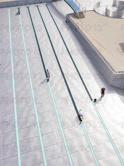 Several people working in an empty swimming pool with metal walls, renovation of the swimming lines, Calw Stammheim outdoor pool, Calw, Black Forest, Germany