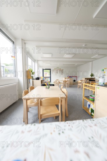 Bright kindergarten room with wooden furniture and large windows, transitional containerised daycare centre, Gechingen daycare centre, Calw district, Germany