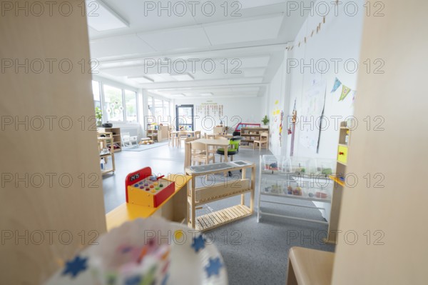 Light-flooded kindergarten room with toys and wall decorations, transitional containerised daycare centre, Gechingen daycare centre, Calw district, Germany
