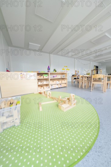 Kindergarten with green carpet and building blocks on the floor, transitional containerised daycare centre, Gechingen daycare centre, Calw district, Germany