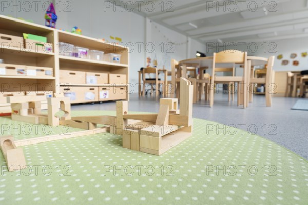 Large play area in the kindergarten with wooden floors and building blocks, transitional containerised daycare centre, Gechingen daycare centre, Calw district, Germany