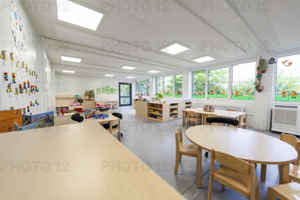 Large, bright nursery room with windows, tables and chairs, wall decorations, transitional containerised nursery, Gechingen nursery, Calw district, Germany