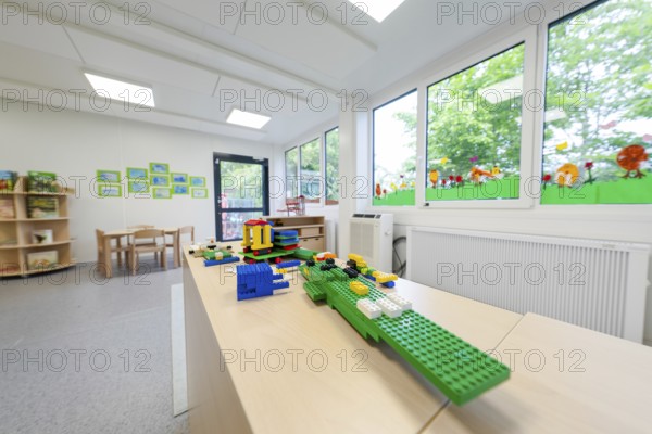 Kindergarten room with building blocks on a table, large windows with a view of the countryside, transitional daycare centre in container construction, Gechingen daycare centre, Calw district, Germany