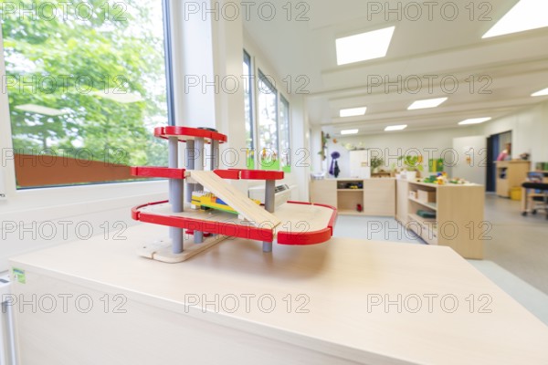 Kindergarten room with a red race track for toy cars and large windows, transitional containerised daycare centre, Gechingen daycare centre, Calw district, Germany