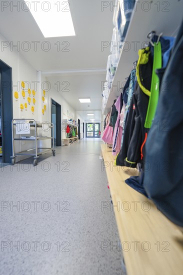 Corridor with shelves full of bags and a trolley, bright and organised atmosphere, transitional daycare centre in container construction, Gechingen daycare centre, Calw district, Germany