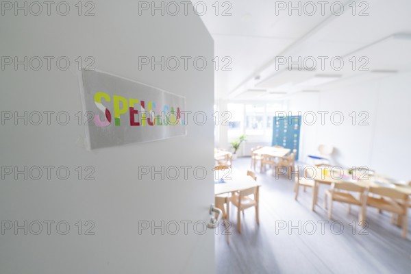 Bright classroom view through an open door with the sign 'Spessart', transitional daycare centre in container construction, Gechingen daycare centre, Calw district, Germany