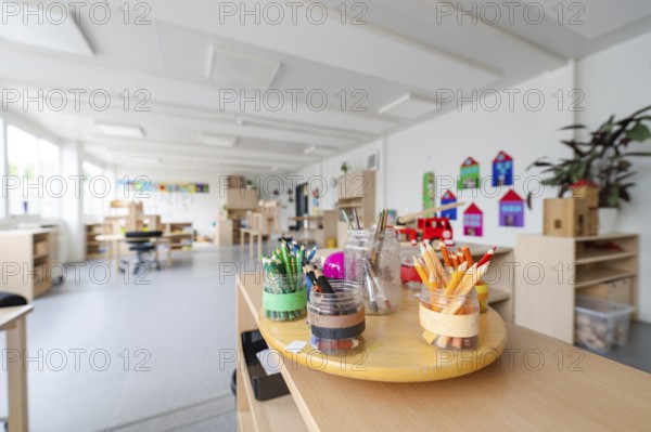 Art area with neatly arranged coloured pencils on a table, transitional daycare centre in container construction, Gechingen daycare centre, Calw district, Germany