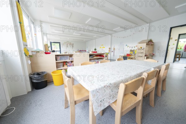 Inviting table area in the kindergarten with decorations and toys, transitional containerised daycare centre, Gechingen daycare centre, Calw district, Germany
