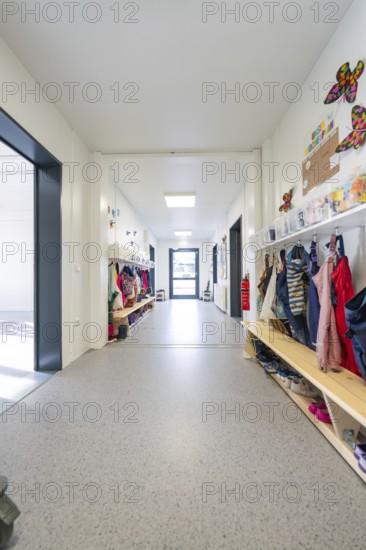 Bright corridor in a kindergarten full of children's clothes and colourful decorations, transitional daycare centre in container construction, Gechingen daycare centre, Calw district, Germany