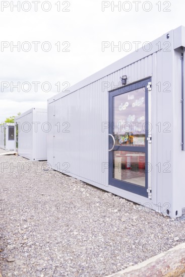 Grey containers with doors in a functional outdoor area, transitional daycare centre in container construction, Gechingen daycare centre, Calw district, Germany