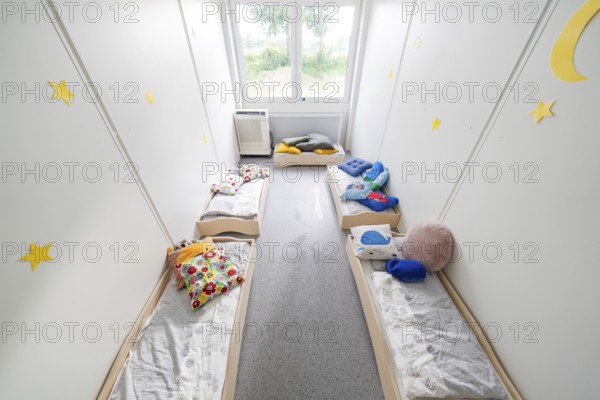 Relaxation room with small beds, soft blankets and decorative elements on the walls, transitional daycare centre in container construction, Gechingen daycare centre, Calw district, Germany