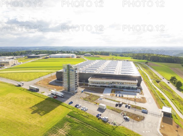 Large industrial facility in a rural setting with vehicles and wide fields, ING Park development area, Zweckverband INGpark Nagold Gäu, Nagold, Germany