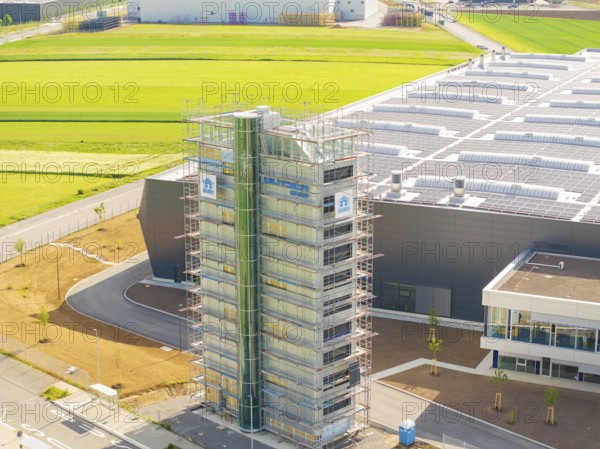 Industrial building with scaffolding and solar panels, surrounded by green fields, ING Park development area, Zweckverband INGpark Nagold Gäu, Nagold, Germany