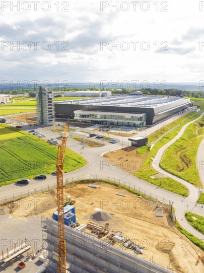 Large industrial building under construction with crane in rural surroundings, ING Park development area, Zweckverband INGpark Nagold Gäu, Nagold, Germany