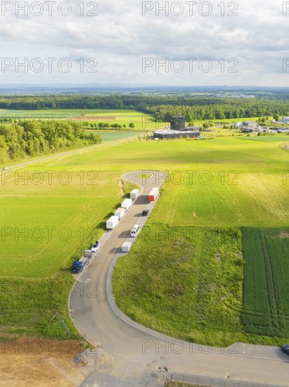 Country road with parked vehicles and extensive fields in a rural setting, ING Park development area, Zweckverband INGpark Nagold Gäu, Nagold, Germany