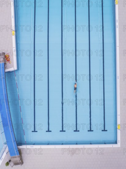 A swimmer in an empty swimming pool, bird's eye view, Calw outdoor pool, Black Forest, Germany