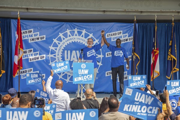 Detroit, Michigan USA - 7 June 2025 - United Auto Workers President Shawn Fain (left) joins Rev. Solomon Kinloch on stage as the UAW supports Kinloch's candidacy for mayor of Detroit. Kinloch is a former UAW member and now pastor of the nondenominational Triumph Church, which has 40, 000 members in eight locations