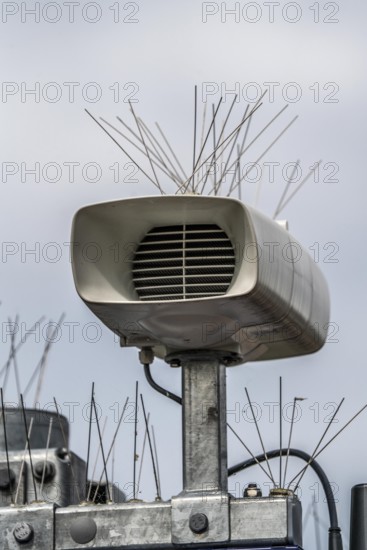 Loudspeakers on a scoreboard, at a railway station, studded with thin wires against birds, pigeons, to keep the technical equipment free of bird droppings, bird defence, pigeon defence