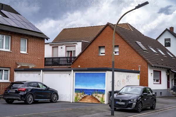 Residential neighbourhood, residential street in Dortmund-Marten, multi-family houses, garages, one with a beach-sea panorama painting, home