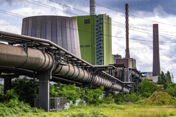 Pipelines for various gases, blast furnace gas, Thyssenkrupp Steel steelworks in Duisburg-Bruckhausen, in front the gas-fired Hamborn power station, green façade of boiler house Block5, North Rhine-Westphalia, Germany