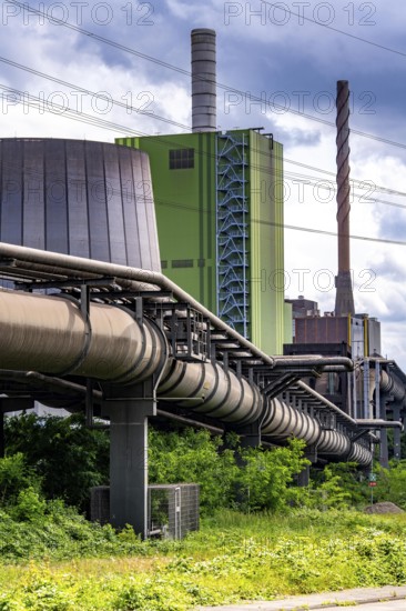 Pipelines for various gases, blast furnace gas, Thyssenkrupp Steel steelworks in Duisburg-Bruckhausen, in front the gas-fired Hamborn power station, green façade of boiler house Block5, North Rhine-Westphalia, Germany