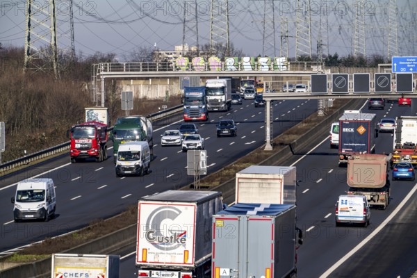 A57 motorway near Kaarst in the Rhein-Kreis Neuss, view towards Kaarst motorway junction, heavy traffic, overhead line, high-voltage lines, along the motorway, North Rhine-Westphalia, Germany