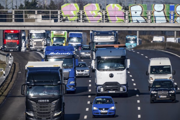 A57 motorway near Kaarst in the Rhein-Kreis Neuss, view towards Kaarst motorway junction, direction Cologne, heavy traffic, sign bridge with graffiti, North Rhine-Westphalia, Germany