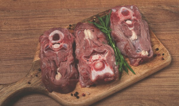 Raw steak, calf's neck on the bone, fresh meat, on the cutting board, top view, no people
