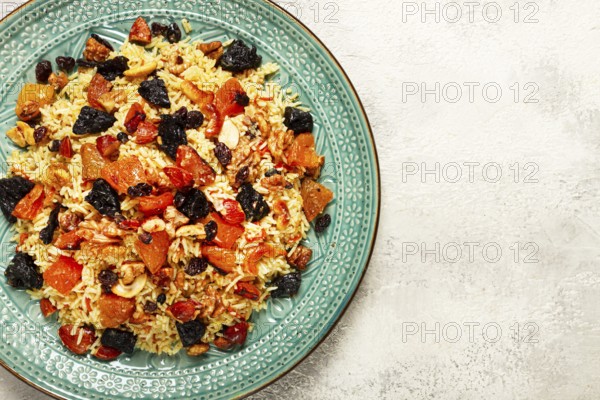 Rice dish, with the addition of dried fruits, nuts and spices of Middle Eastern cuisine, homemade, no people