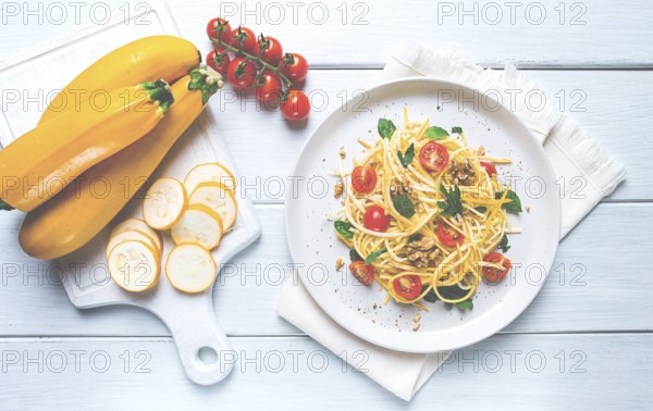 Yellow zucchini salad, with cherry, vegetarian food, sliced into strips, homemade