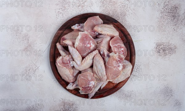 Raw chicken wings, on a wooden board, top view, no people