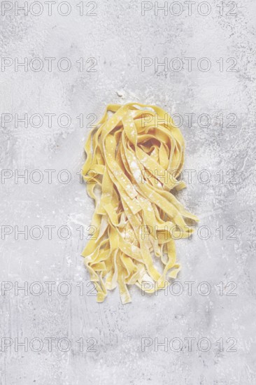 Raw tagliatelli pasta, homemade, top view, no people, rustic, food concept