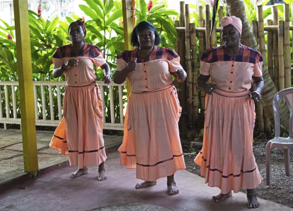 Guatemalan woman in traditional clothing singing and dancing, Garifuna people, Livingston, Izabal Department, Guatemala