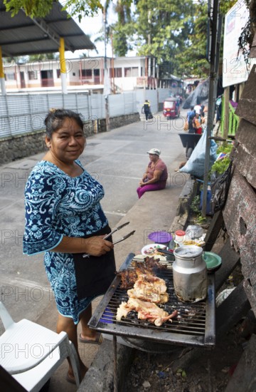 Guatemalan woman on street grill, Livingston, Izabal Department, Guatemala