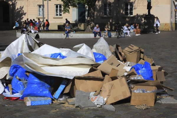 A pile of waste paper and cardboard on the street, remnants of an event, trash, trash, here in Oldenburg, Lower Saxony, Germany
