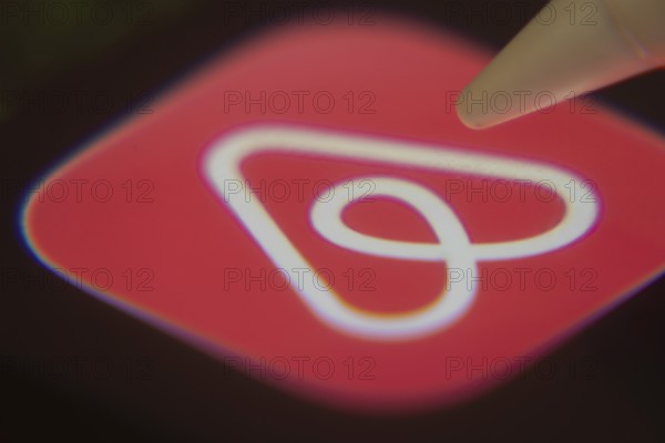 Dhaka, Bangladesh- 06 Dec 2025: Close-up of the Airbnb app on a screen with a stylus pointing at it