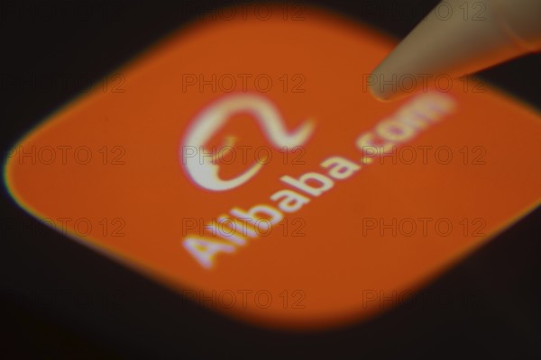 Dhaka, Bangladesh- 06 Dec 2025: Close-up of the Alibaba app on a screen with a stylus pointing at it