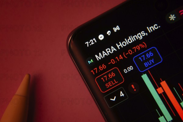 Dhaka, Bangladesh- 08 Sep 2025: Close-up of a phone screen showing MARA Holdings Inc stock market data with a candlestick chart