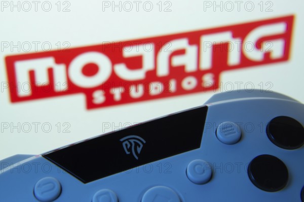 Dhaka, Bangladesh- 24 Mar 2025: A close-up of a gamepad with the Mojang Studios seen on screen in the background