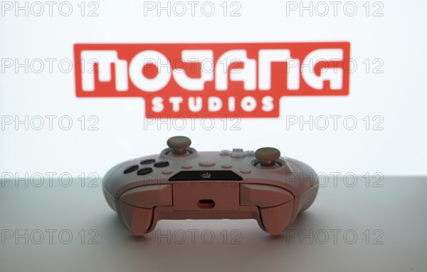 Dhaka, Bangladesh- 08 Apr 2025: A gaming controller in front of a Mojang Studios screen