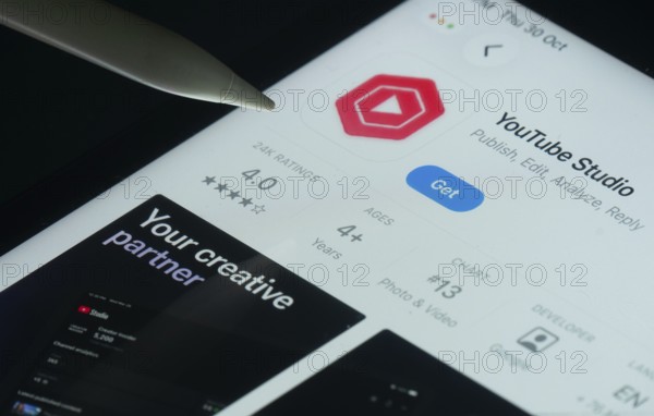 Dhaka, Bangladesh- 30 Oct 2025: Youtube Studio app on a iPad screen with a pen pointing at the install option