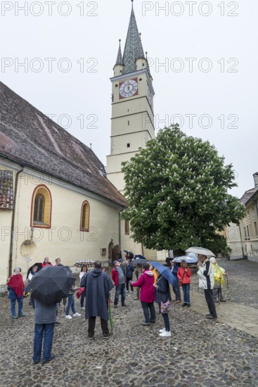 Tour group in the courtyard of St. Margaret's Church, Medias, Romania