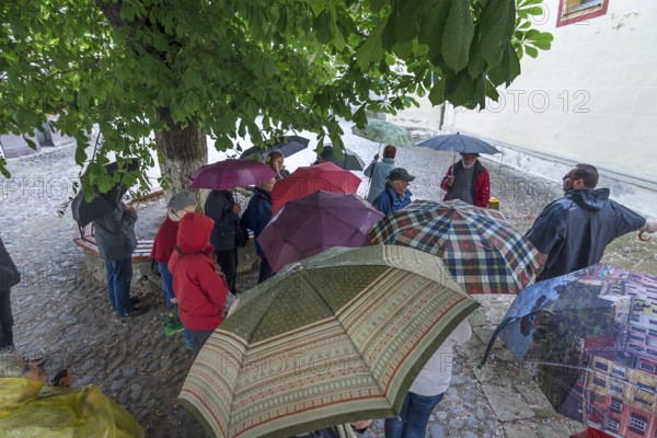 Tour group in the courtyard of St. Margaret's Church, Medias, Romania