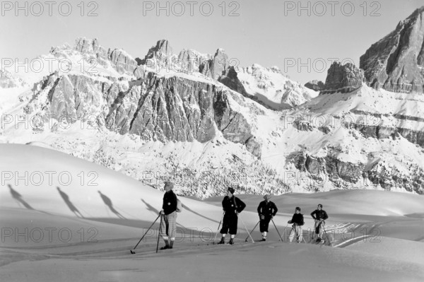 Winter skiing in front of the group Lagazuoi da Nuvolao, snow, group, Alps, mountaineers, skiers, around 1930, high mountains, mountain, historical, Ampezzo Dolomites, South Tyrol, Veneto, Italy