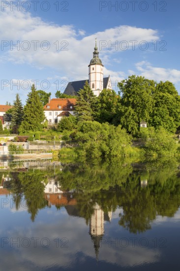 City view with church of Our Lady on the mountains and reflection in Zwickauer Mulde, Penig, Saxony, Germany