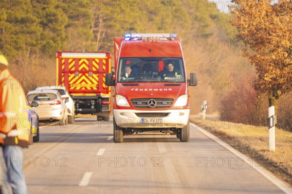 Two fire engines drive on a country road, road markings visible, fire brigade exercise on the Hermann Hesse Railway, Ostelsheim, Calw district, Germany